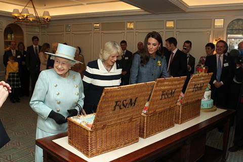 The Queen, the then-Duchess of Cornwall and the Duchess of Cambridge take a look inside Fortnum & Mason’s famous hampers during that same visit in March 2012